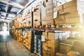 Cargo cardboard boxes for shipping and delivery in logistic storage warehouse hangar, interior of storehouse inside Royalty Free Stock Photo