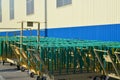 Cargo carts stand near the building of modern plant