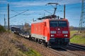 Cargo class locomotive with red wagons passing through Saarmund, Germany