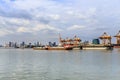 Cargo container ship being towed by the tug of cruising through the city Royalty Free Stock Photo