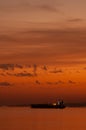 Cargo container ship at mediterranean coast in sunset