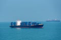 Cargo container ship sailing through blue, calm ocean. Royalty Free Stock Photo