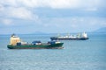 Cargo ship sailing through peaceful, calm, blue sea. Royalty Free Stock Photo