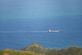 Cargo Container Ship on the sea near the coast and mountains Royalty Free Stock Photo