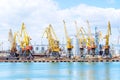 Cargo container terminal of sea freight industrial port. Port cargo cranes over blue sky background. Large elevator in the s Royalty Free Stock Photo