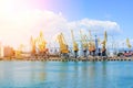 Cargo container terminal of sea freight industrial port. Port cargo cranes over blue sky background. Large elevator in the s Royalty Free Stock Photo