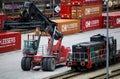 Poznan, Poland - February 26th 2022: Cargo container transshipment lift with CARGOUNIT locomotive on the right.