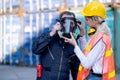 Cargo container woman worker help technician to wear gas protective mask and prepare for manage the problem in workplace area