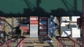 Cargo containers stacked during unloading at shipping dock Royalty Free Stock Photo