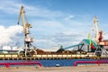 Cargo crane in the port of the Baltic against the blue sky in summer Royalty Free Stock Photo