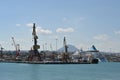 Cargo cranes in port of Heraklion, Crete, waiting for merchant ships to load and discharge cargo.