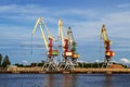Cargo cranes in terminal in river ship port in Ventspils, Latvia, Baltic sea. Royalty Free Stock Photo