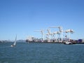 Cargo Cranes, tugboat and sail boat in Oakland Harbor on a nice