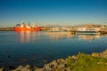 Cargo and cruise tour ships at Ushuaia harbor in Tierra del Fuego National Park at sunset, Patagonia, Argentina, golden Autumn