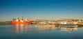 Cargo and cruise tour ships at Ushuaia harbor in Tierra del Fuego National Park at sunset, Patagonia, Argentina, golden Autumn