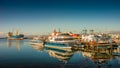 Cargo and cruise tour ships at Ushuaia harbor in Tierra del Fuego National Park at sunset, Patagonia, Argentina, golden Autumn