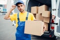 Cargo delivery, male courier with box in hand