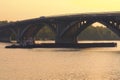 Cargo delivery by river transport. The tug boat towing an empty barge. Metro Bridge in the background. Autumn morning landscape Royalty Free Stock Photo