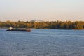 Cargo delivery by river transport. The tug boat towing an empty barge. Scenic morning autumn landscape of Kyiv. Nature landscape. Royalty Free Stock Photo