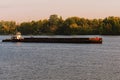 Cargo delivery by river transport. The tug boat towing an empty barge. Scenic morning autumn landscape of Kyiv. Nature landscape. Royalty Free Stock Photo