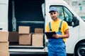 Cargo delivery service, male courier unload truck Royalty Free Stock Photo