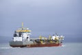 Cargo export container carrier ship vessel on sea under dark sky Royalty Free Stock Photo