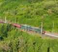 The cargo freight train moves by rail in the evening