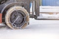 Cargo loader in winter on snow. The loader ride on snow with chains on the wheels to reduce slippage and spin. Driving