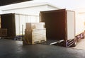 Cargo Package Boxes Loading into Shipping Cargo Container. Trucks Parked Loading at Dock Warehouse. Commece Supply Chain Shipment Royalty Free Stock Photo