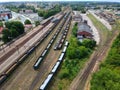 Cargo and passenger wagons on train station in city, aerial view. Royalty Free Stock Photo