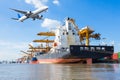 Cargo plane flying above ship port for logistic import export Royalty Free Stock Photo