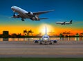 Cargo plane flying over airport against beautiful morning light Royalty Free Stock Photo