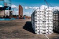 Cargo at the port. Aluminum ingots on the pier. Against the background of cargo depots and ships