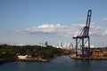 Cargo port with crane & shipping containers along the entrance to the Panama Canal, with Panama city in the background Royalty Free Stock Photo
