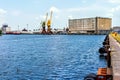 Cargo port and harbour in Szczecin with cargo ship, dock cranes and industrial machinery