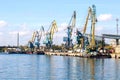 Cargo port with tower cranes on a river Royalty Free Stock Photo