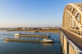 Cargo river barges passing under waal bridge in Nijmegen