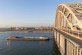 cargo river barges passing under waal bridge in Nijmegen during time of low river levels