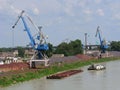 Cargo river port on the Danube, tugboat and river barge with iron ore Royalty Free Stock Photo