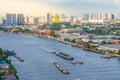 Cargo and sand ships pass the new Thai parliament on the Chao Phraya River Royalty Free Stock Photo