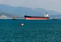 Cargo ship anchored in the roadstead Tsemes bay at the entrance of the port of Novorossiysk Royalty Free Stock Photo