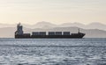 cargo ship on the background of blurred mountains Royalty Free Stock Photo