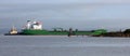 Cargo ship being guided past the lighthouse into the the dock at Portbury United Kingdom at high tide 30-09-2023 Royalty Free Stock Photo