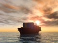 Cargo ship with containers sailing through the sea at sunset Royalty Free Stock Photo