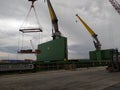 A cargo ship and cranes and machinery in the port of Bilbao, Spain, one morning at dawn