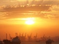 Cargo ship and cranes at port harbour in Tanjung Perak Surabaya with sunset sky background Royalty Free Stock Photo