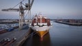 Cargo Ship Docked at Busy Industrial Port Royalty Free Stock Photo