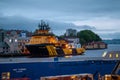 A cargo ship in the evening in the port of Bergen, Norway Royalty Free Stock Photo