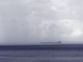 Cargo ship in foggy sea landscape in the estuary Western Sheldt