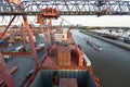 Cargo ship loading containers in Rotterdam. Royalty Free Stock Photo